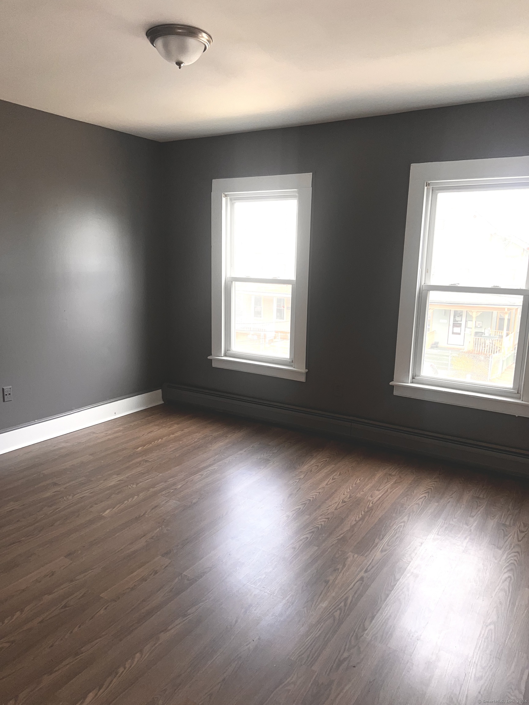 552 Winthrop Avenue New Haven, CT 06511 - Photo 12 of 12 an empty room with wooden floor and windows