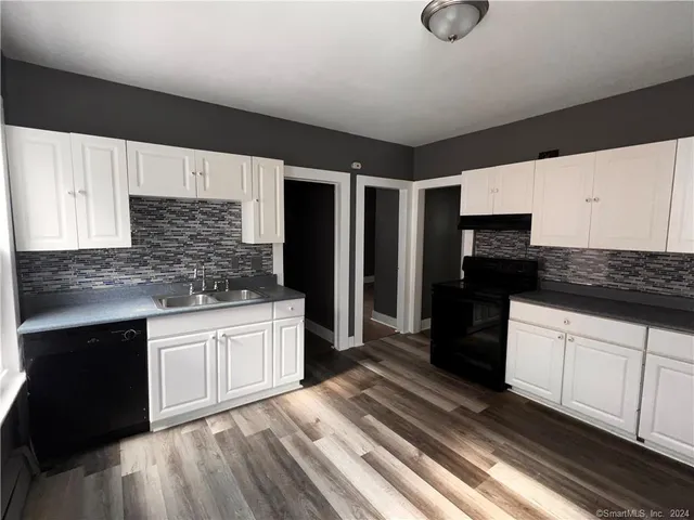 a kitchen with stainless steel appliances granite countertop a refrigerator and a stove