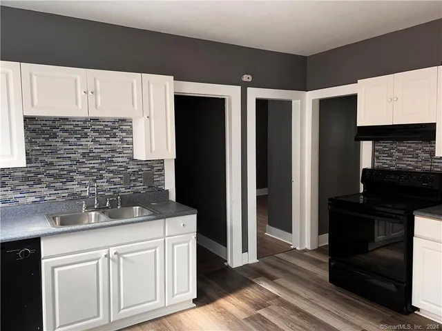 a kitchen with a refrigerator and a sink