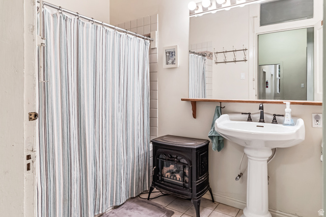 21 North Main Street Kingston, UT 84743 - Photo 41 of 107 Full bath with a wood stove, curtained shower, and tile patterned flooring