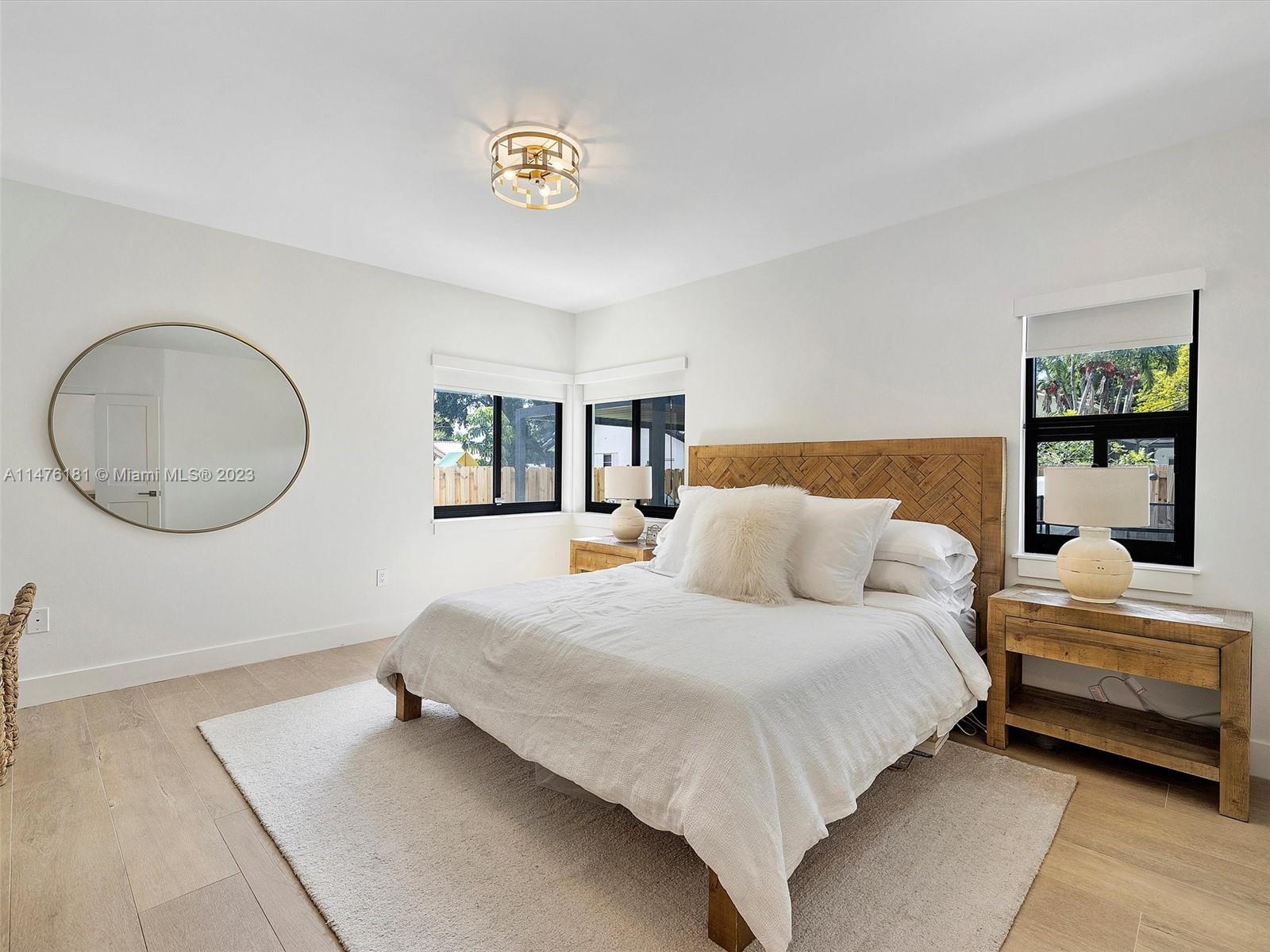 3776 Southwest 107th Court Miami, FL 33165 - Photo 26 of 45 a bedroom with a large bed and a chandelier