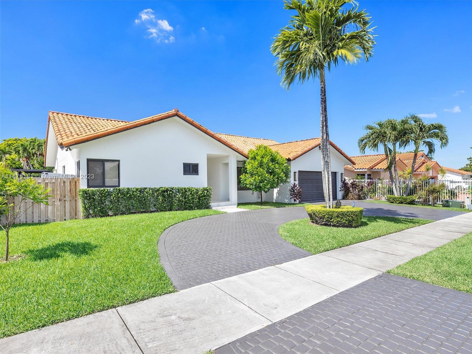 3776 Southwest 107th Court Miami, FL 33165 - Photo 42 of 45 a front view of a house with a garden