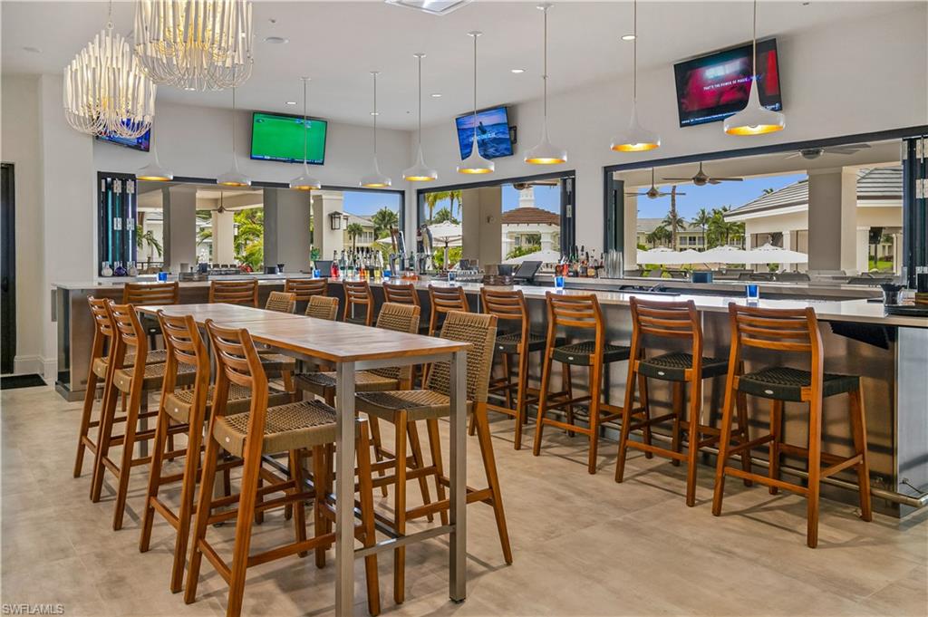 265 Indies Way, Unit T1 Naples, FL 34110 - Photo 15 of 21 a view of a dining area with furniture window and outside view
