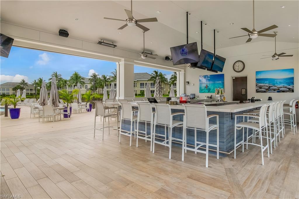 265 Indies Way, Unit T1 Naples, FL 34110 - Photo 17 of 21 a view of a dining room with furniture window and wooden floor