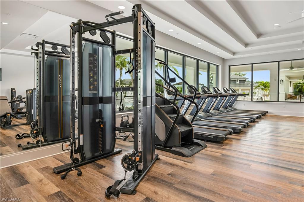 265 Indies Way, Unit T1 Naples, FL 34110 - Photo 19 of 21 a view of a room with gym equipment