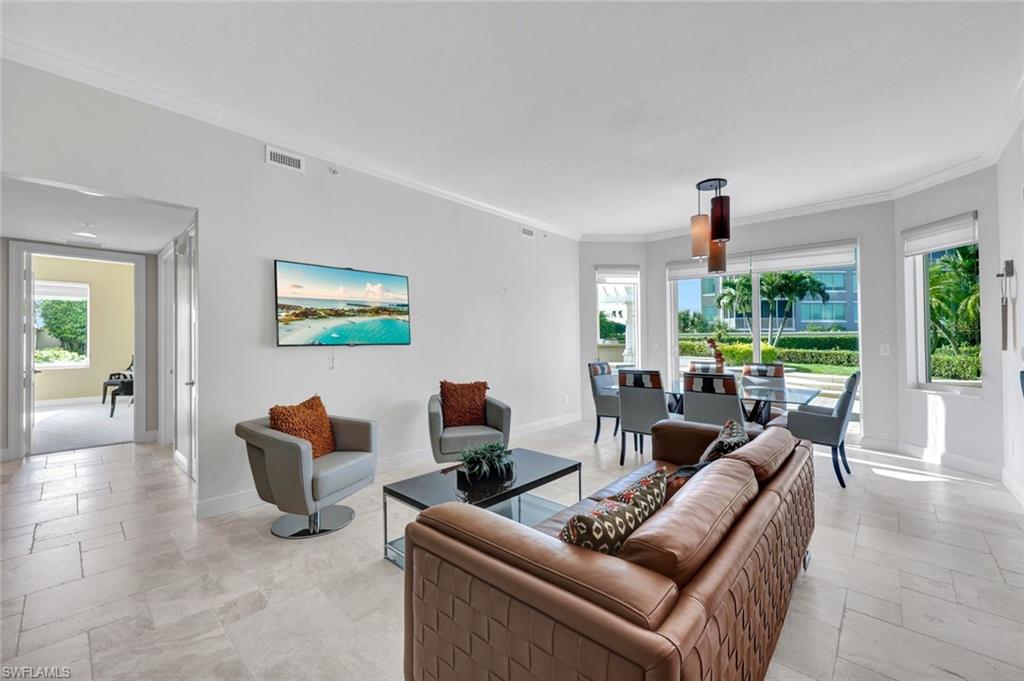 265 Indies Way, Unit T1 Naples, FL 34110 - Photo 2 of 21 a living room with furniture and a large window