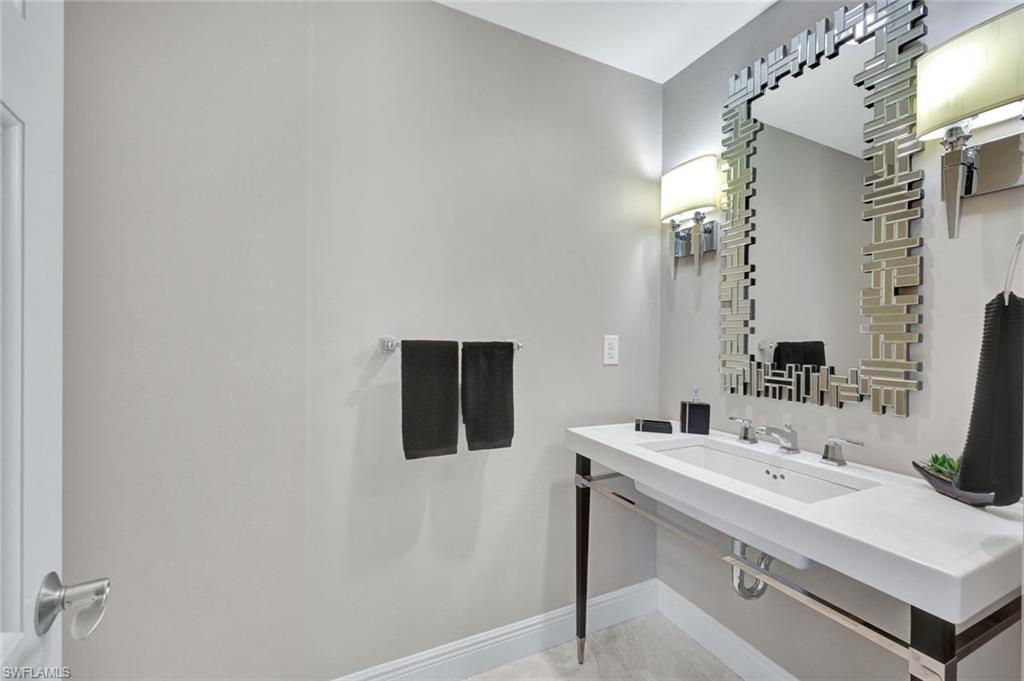 265 Indies Way, Unit T1 Naples, FL 34110 - Photo 6 of 21 a bathroom with a sink and a mirror