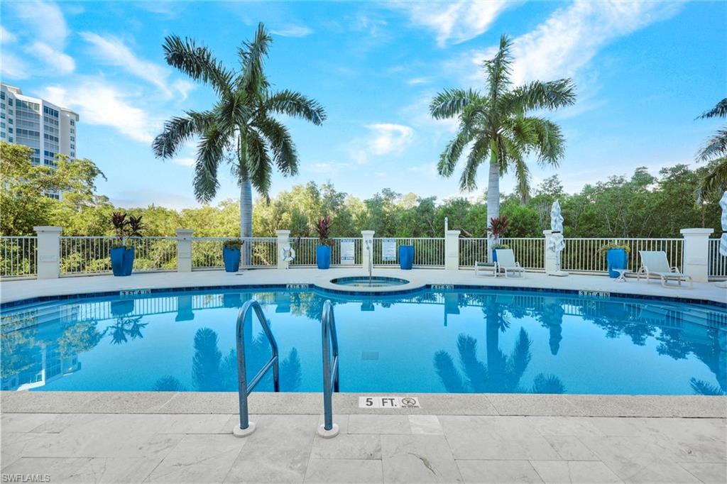 265 Indies Way, Unit T1 Naples, FL 34110 - Photo 9 of 21 a view of a swimming pool with a patio