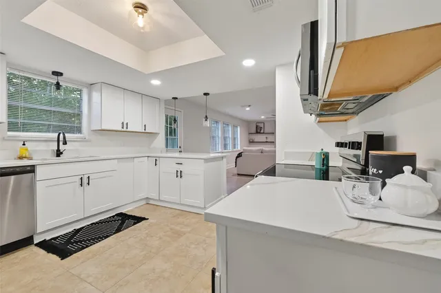 a kitchen with a sink appliances and cabinets