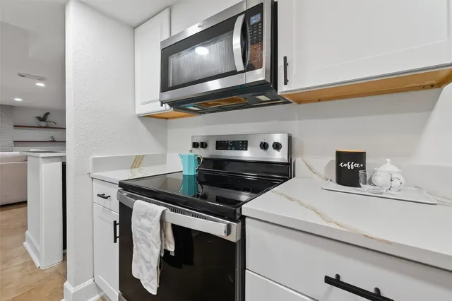 a kitchen with a stove and a microwave