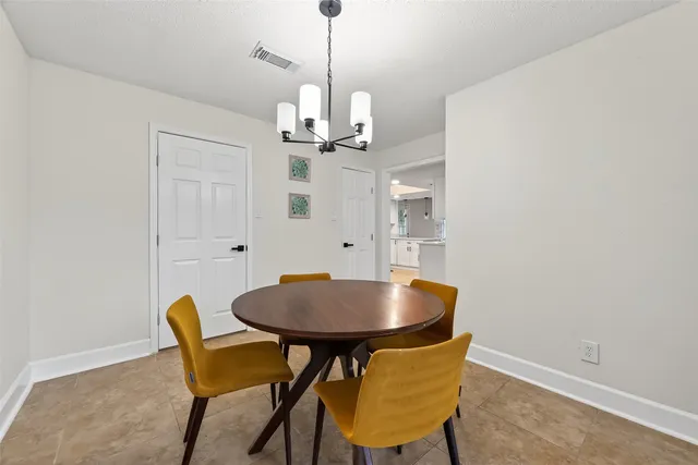 a view of a dining room with a table and chairs