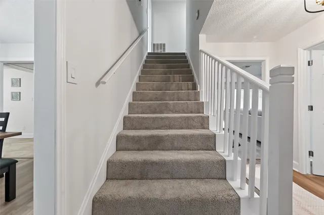 a view of staircase with white walls