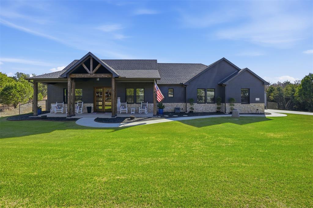 a front view of house with yard and outdoor seating