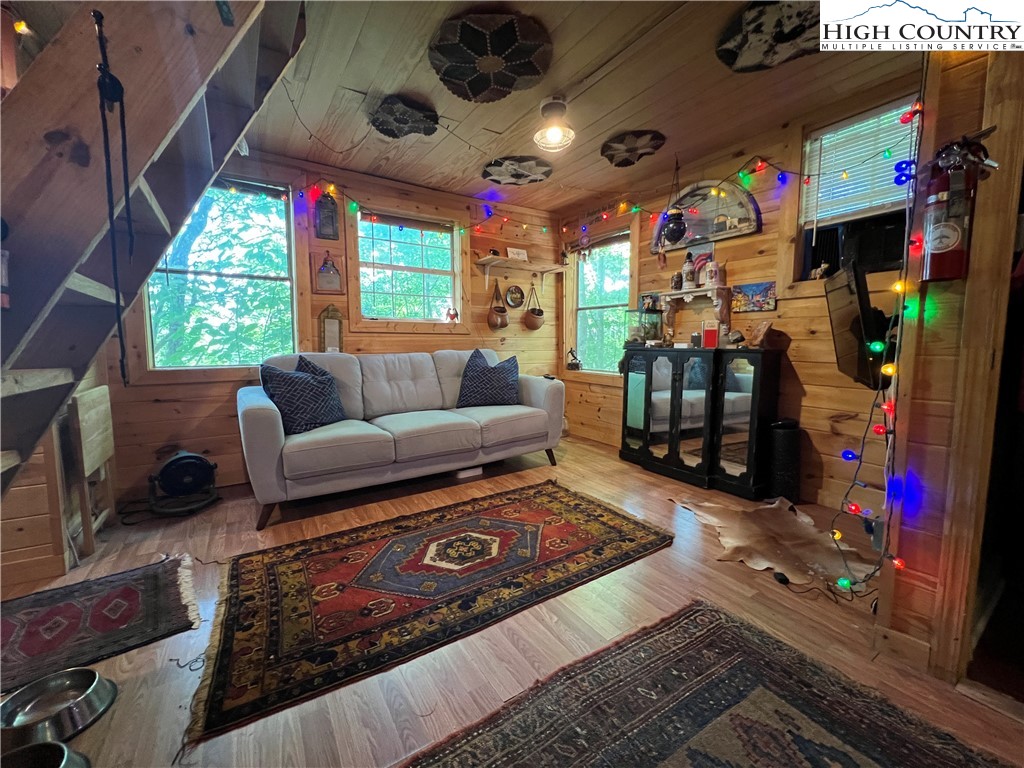 465 Shepherds Run Purlear, NC 28665 - Photo 10 of 47 a living room with furniture and a floor to ceiling window