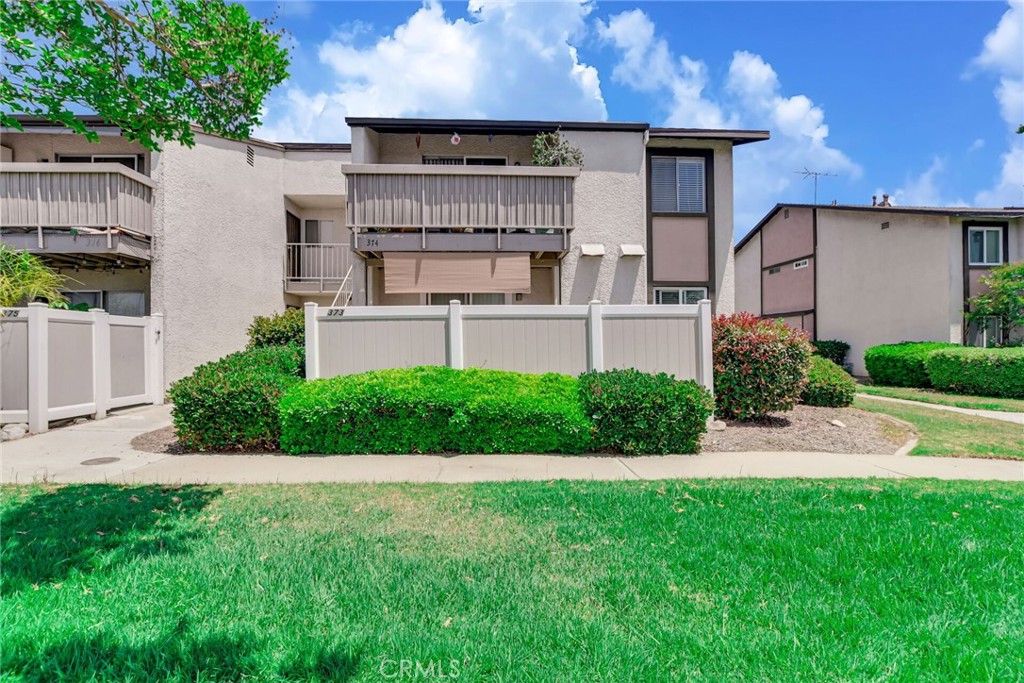 8990 19th Street, Unit 373 Rancho Cucamonga, CA 91701 - Photo 1 of 1 a front view of a house with a yard and potted plants