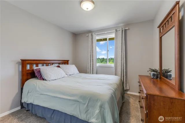 a bedroom with a bed and window