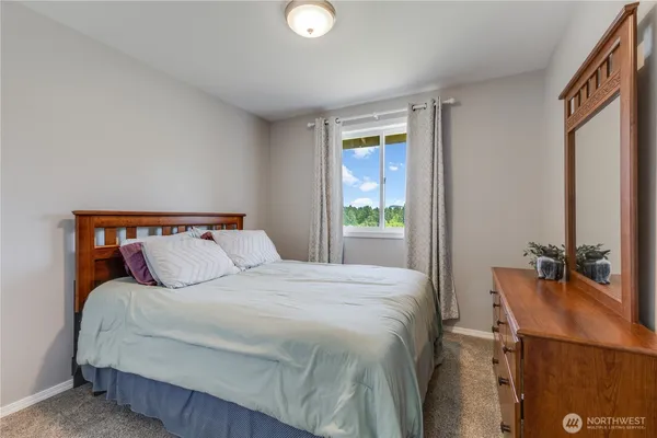 a bedroom with a bed and window