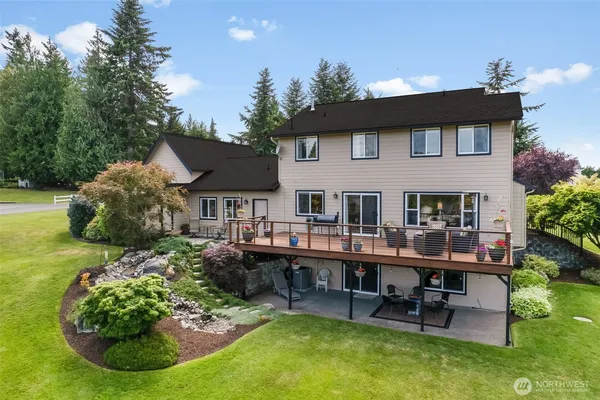 a view of a house with backyard porch and sitting area