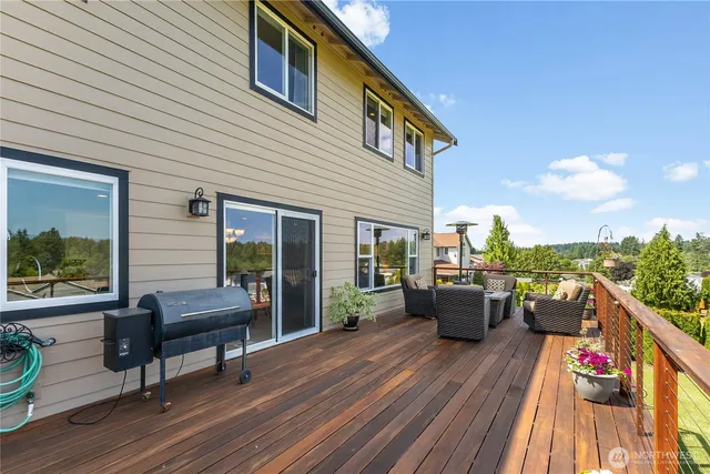 a view of a roof deck with couches and wooden floor