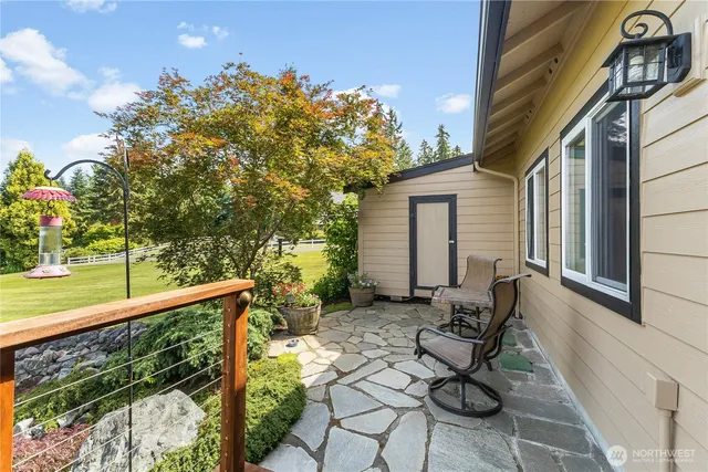 a view of chairs and table in patio with a yard