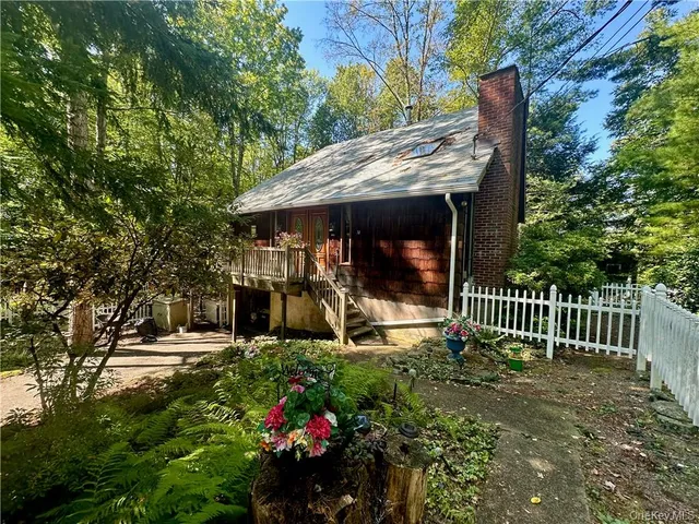 a view of a chair and table in backyard of the house