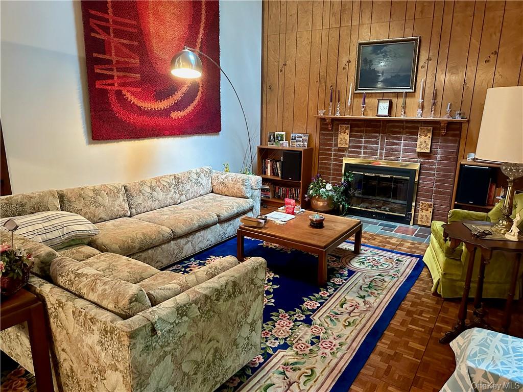 74 Swinging Bridge Estate Road Monticello, NY 12701 - Photo 13 of 36 a living room with furniture a fireplace and a flat screen tv