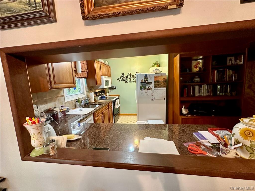 74 Swinging Bridge Estate Road Monticello, NY 12701 - Photo 16 of 36 Kitchen with backsplash, white appliances, and sink