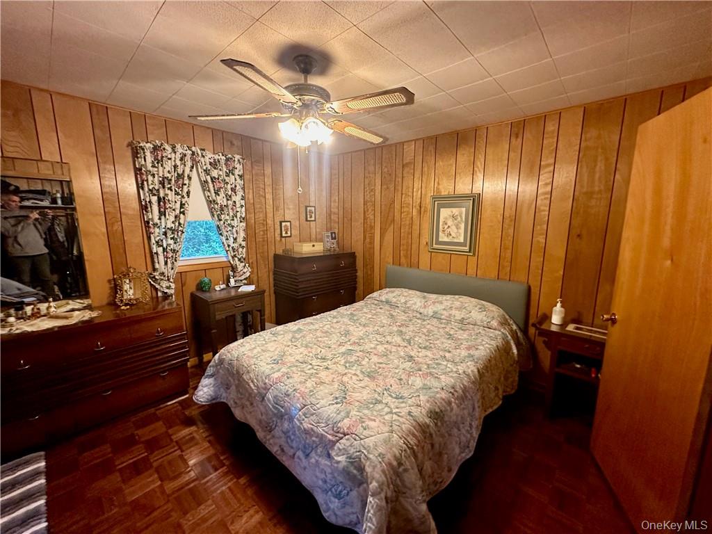 74 Swinging Bridge Estate Road Monticello, NY 12701 - Photo 19 of 36 a bed sitting in a bedroom next to a window