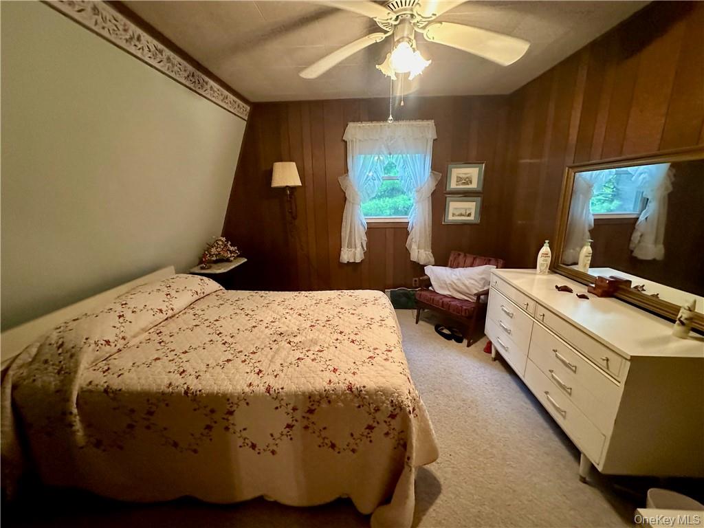 74 Swinging Bridge Estate Road Monticello, NY 12701 - Photo 22 of 36 a spacious bedroom with a bed and window