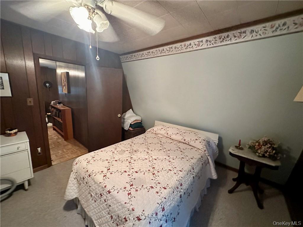 74 Swinging Bridge Estate Road Monticello, NY 12701 - Photo 23 of 36 a bedroom with a bed and a table in it