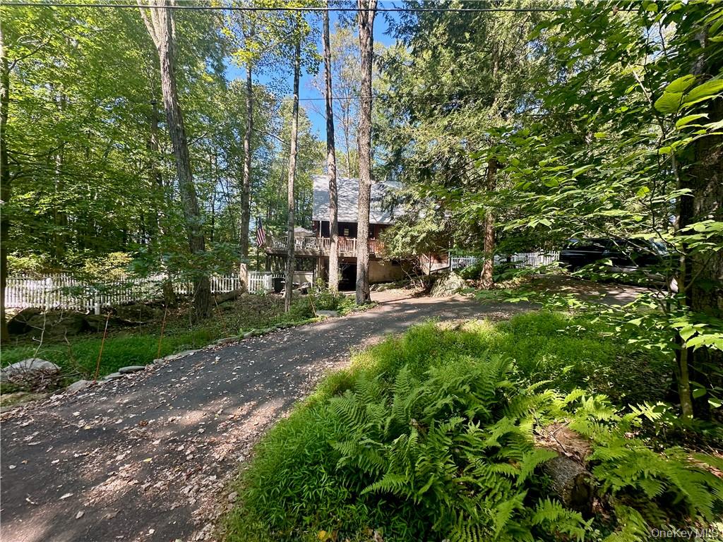 74 Swinging Bridge Estate Road Monticello, NY 12701 - Photo 33 of 36 a view of a building with a tree