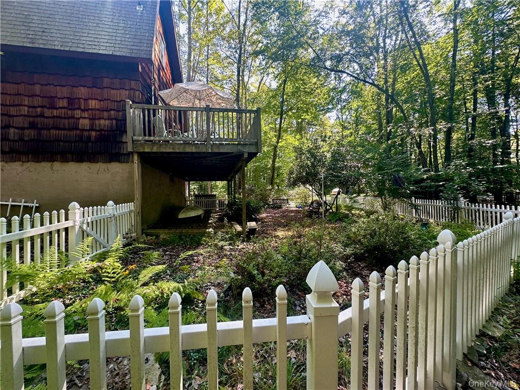 74 Swinging Bridge Estate Road Monticello, NY 12701 - Photo 4 of 36 a view of a house with wooden deck and furniture