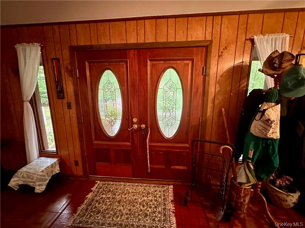 74 Swinging Bridge Estate Road Monticello, NY 12701 - Photo 9 of 36 Foyer entrance with wooden walls and a healthy amount of sunlight
