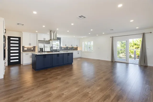 a kitchen with stainless steel appliances sink refrigerator and cabinets