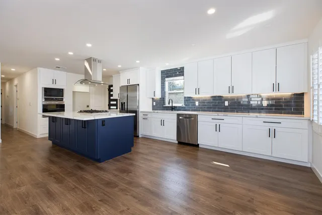 a kitchen with a sink stainless steel appliances and cabinets