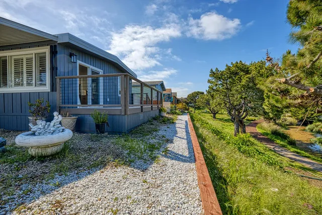 a view of balcony with wooden floor and fence