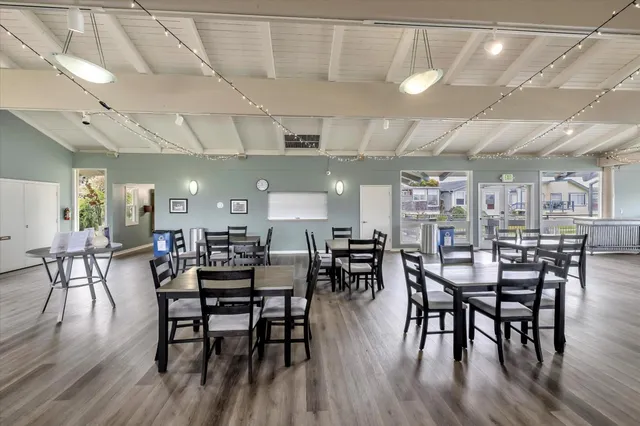 a balcony with outdoor seating and city view