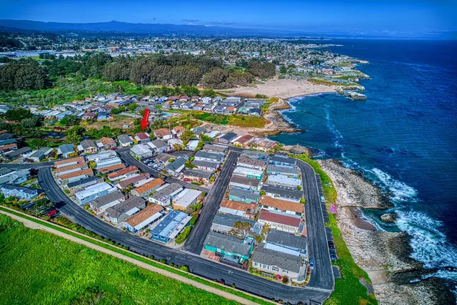 an aerial view of multiple houses with a yard