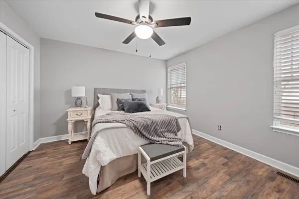 a bedroom with a bed and a chandelier