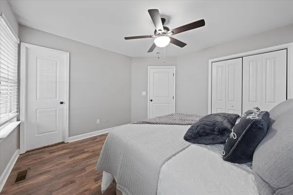 a bedroom with a bed and a window