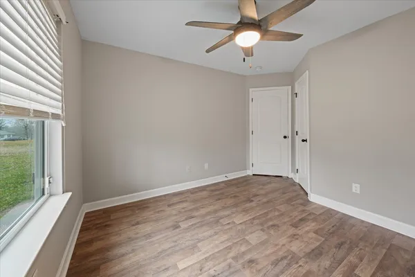 wooden floor in an empty room with a window