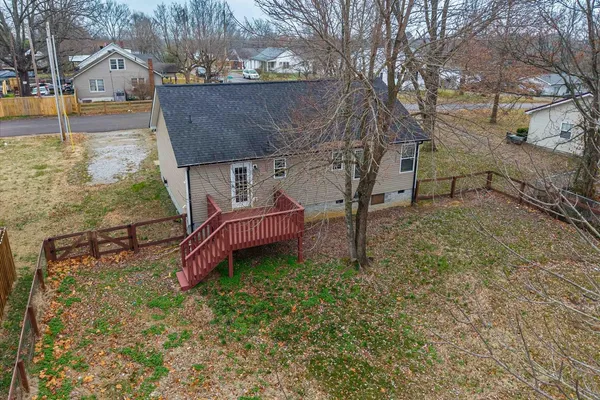 a view of a backyard with wooden fence