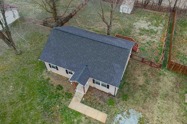 an aerial view of a house with yard