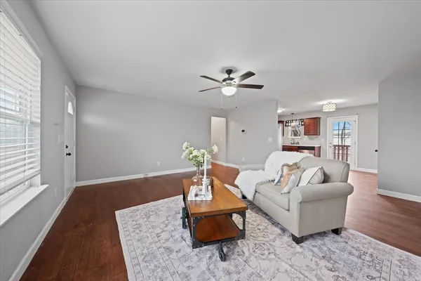 a living room with furniture and a wooden floor
