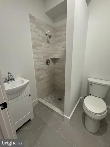 a bathroom with a toilet sink and shower