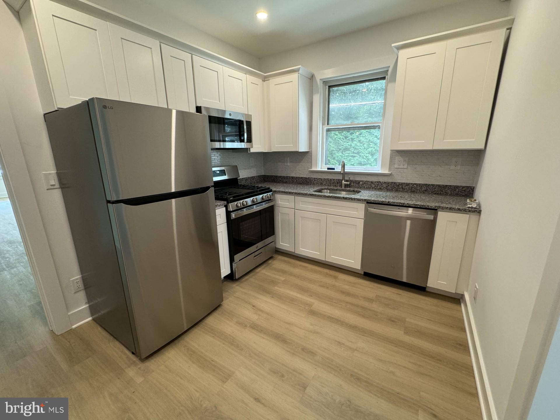 37 Bank Street, Unit 1 Princeton, NJ 08542 - Photo 4 of 4 a kitchen with granite countertop a refrigerator stove a sink and dishwasher