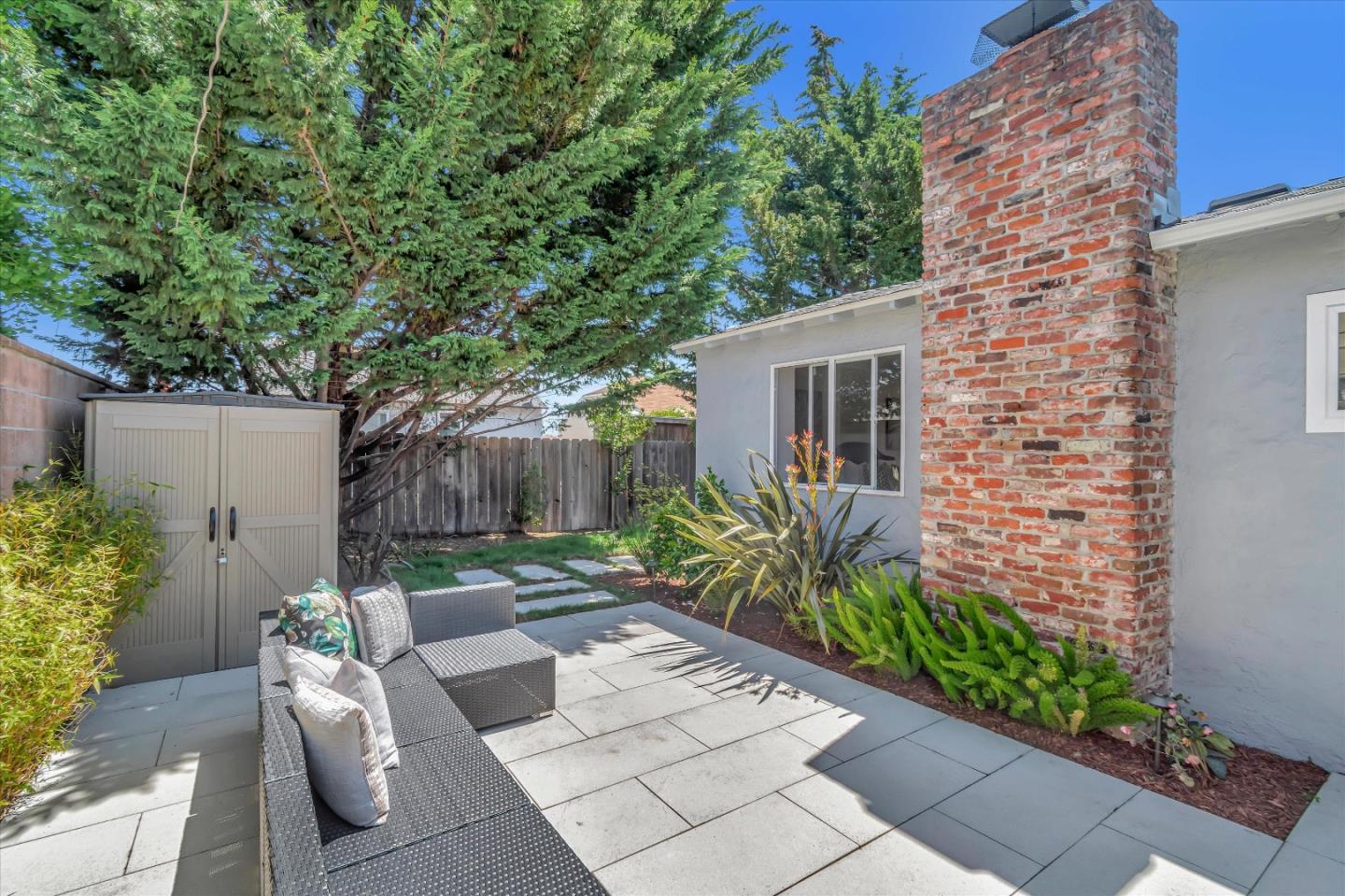 714 Cherry Avenue San Bruno, CA 94066 - Photo 23 of 29 a view of a backyard with potted plants and a large tree