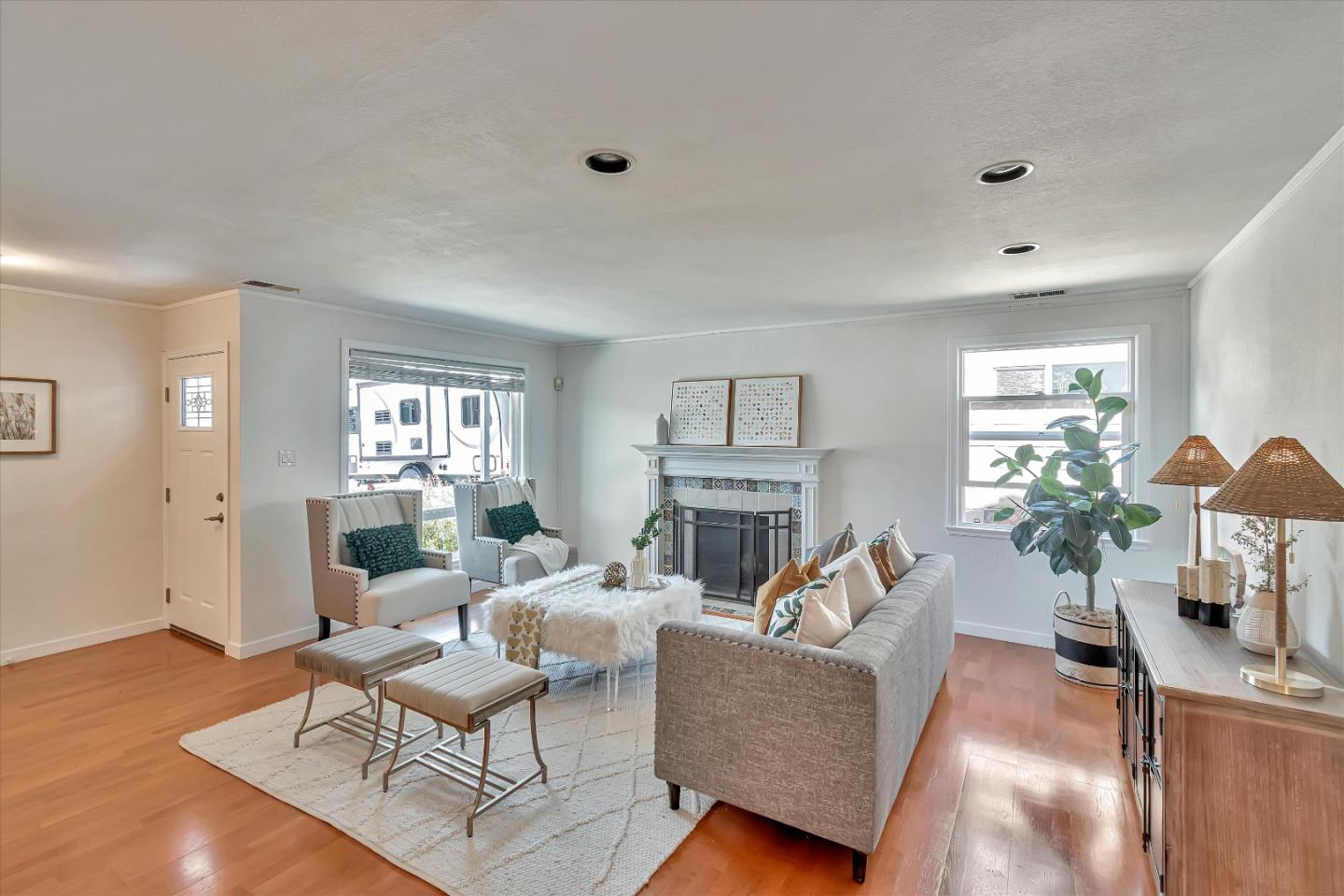 714 Cherry Avenue San Bruno, CA 94066 - Photo 4 of 29 a living room with furniture a fireplace and a potted plant