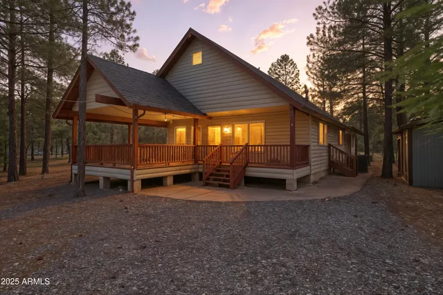 a view of backyard with wooden fence and trees