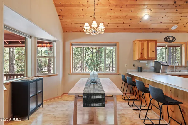 a kitchen with stainless steel appliances granite countertop a refrigerator a sink a stove and white cabinets